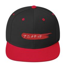 Load image into Gallery viewer, Black and Red snapback hat with Animeted Brand's red paintbrush logo written in Japanese Katakana.