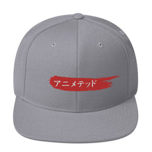 Load image into Gallery viewer, Silver snapback hat with Animeted Brand's red paintbrush logo written in Japanese Katakana.