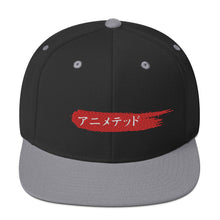 Load image into Gallery viewer, Black and Silver snapback hat with Animeted Brand&#39;s red paintbrush logo written in Japanese Katakana.
