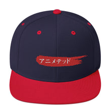 Load image into Gallery viewer, Navy and Red snapback hat with Animeted Brand&#39;s red paintbrush logo written in Japanese Katakana.
