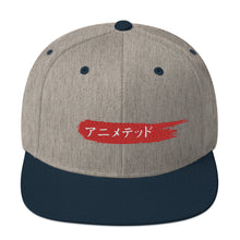 Load image into Gallery viewer, Heather Gray and Navy snapback hat with Animeted Brand&#39;s red paintbrush logo written in Japanese Katakana.
