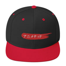 Load image into Gallery viewer, Black and Red snapback hat with Animeted Brand&#39;s red paintbrush logo written in Japanese Katakana.
